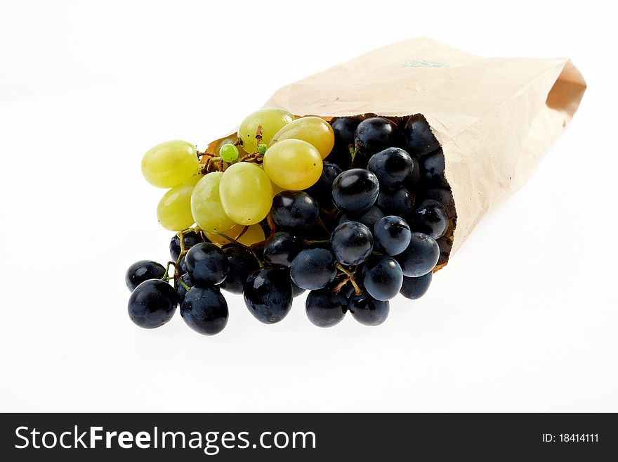 Fresh grapes in paper bag isolated on white