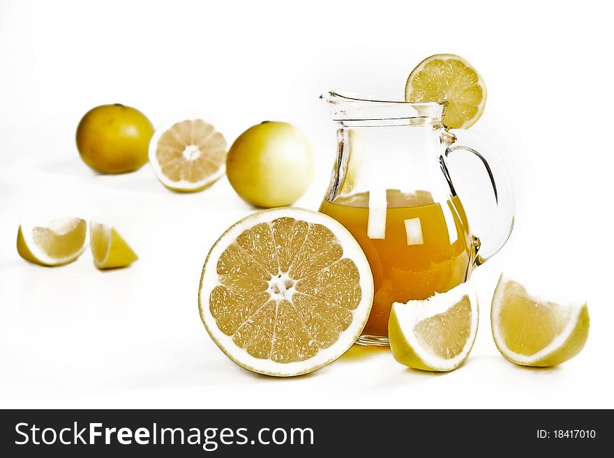 Fresh grapefruit juice and fruits isolated on white. Fresh grapefruit juice and fruits isolated on white.