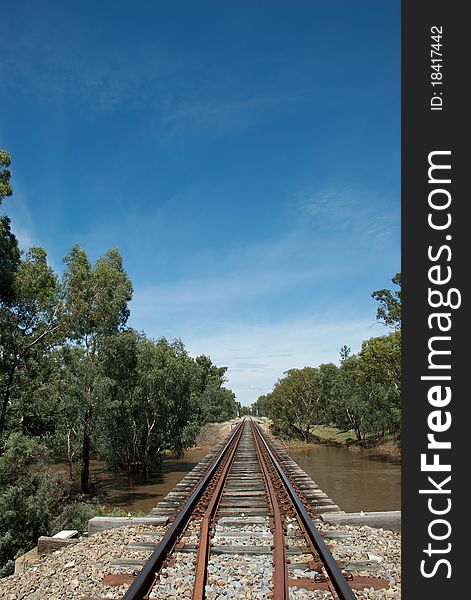 A railway line over a local creek. A railway line over a local creek