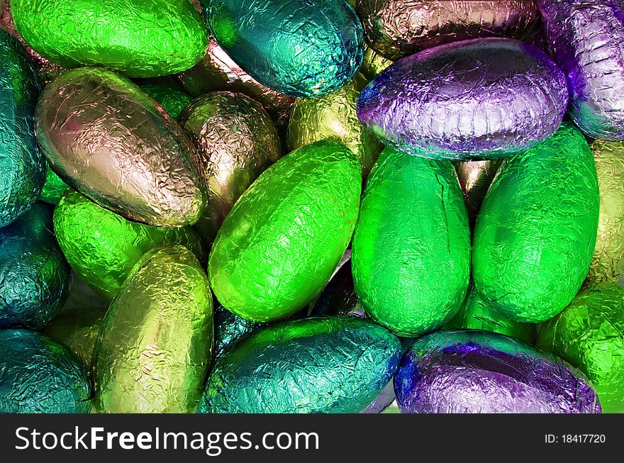 Variety chocolate easter eggs wrapped in colorful neon shiny foil. Variety chocolate easter eggs wrapped in colorful neon shiny foil