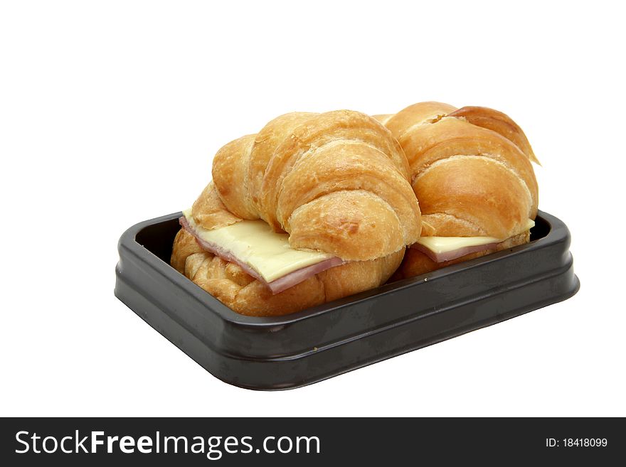 Closeup of two Ham Cheese croissants in brown tray