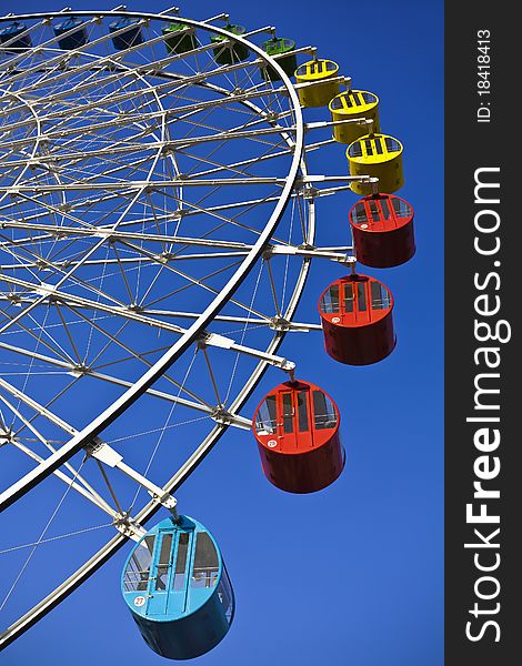 A giant wheel at an amusement park. A giant wheel at an amusement park.