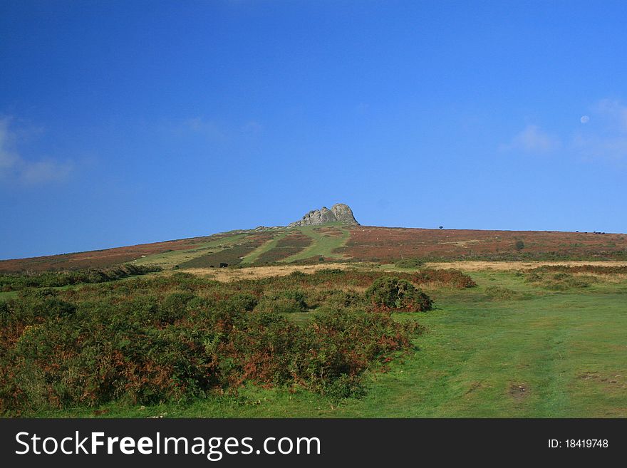 Moon over Haytor Rocks at dawn on Dartmoor, Devon