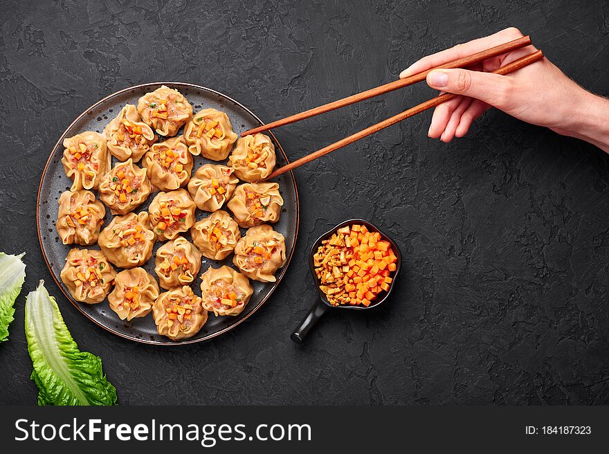 Shumai Or Kanom Jeeb Or Steamed Pork And Shrimp Dumplings On A Black Plate On Dark Slate Backdrop. Chinese Food. Asian Meal