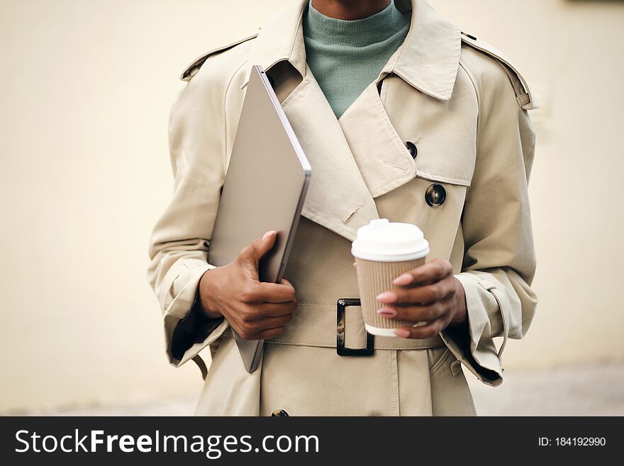 Close Up Woman In Stylish Trench Coat With Laptop And Coffee To Go Outdoor
