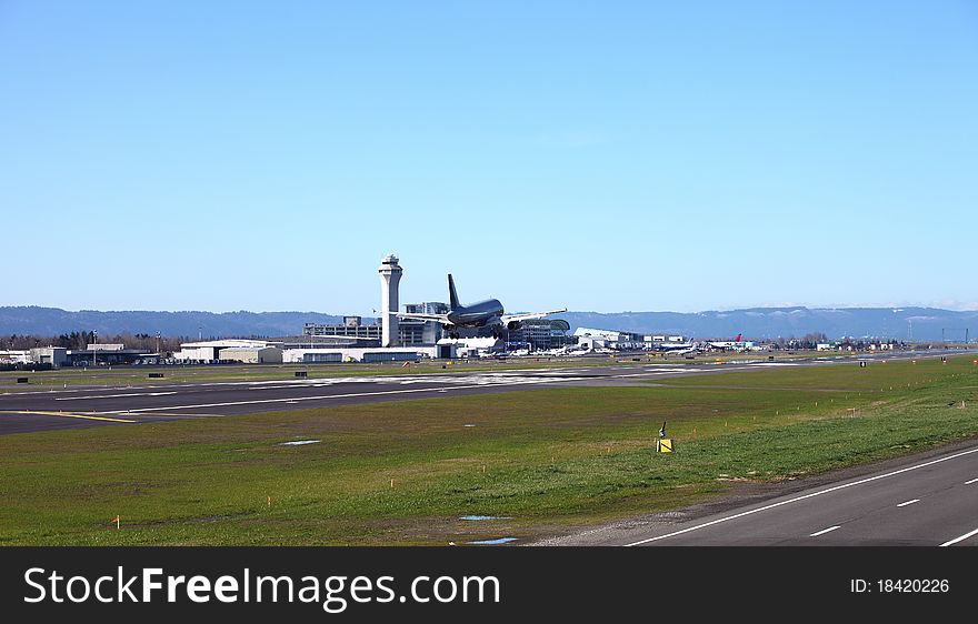 A passenger jetliner landing in Portland Oregon airport. A passenger jetliner landing in Portland Oregon airport.