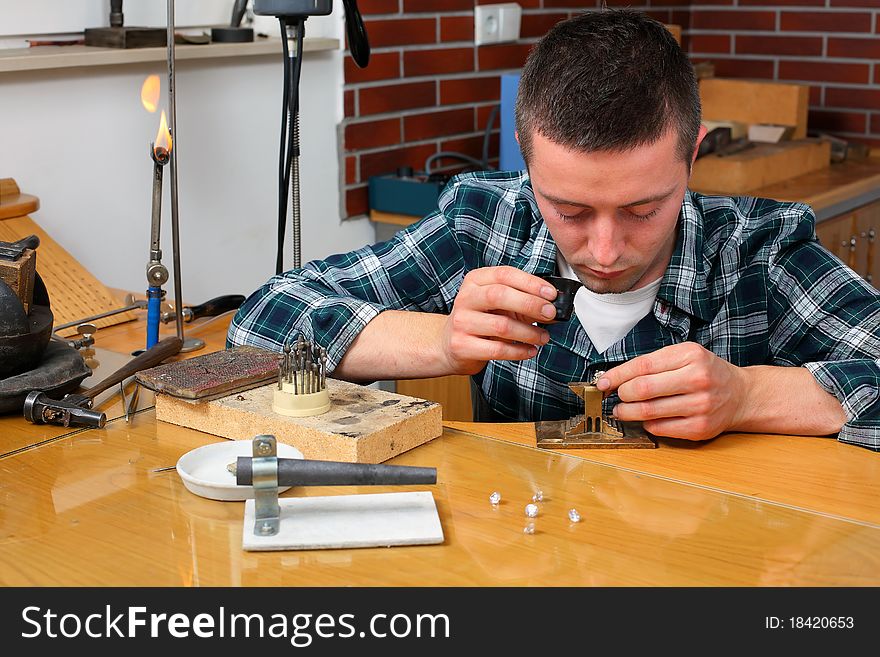 Goldsmith in workshop. Making of jewelery. Handmade.