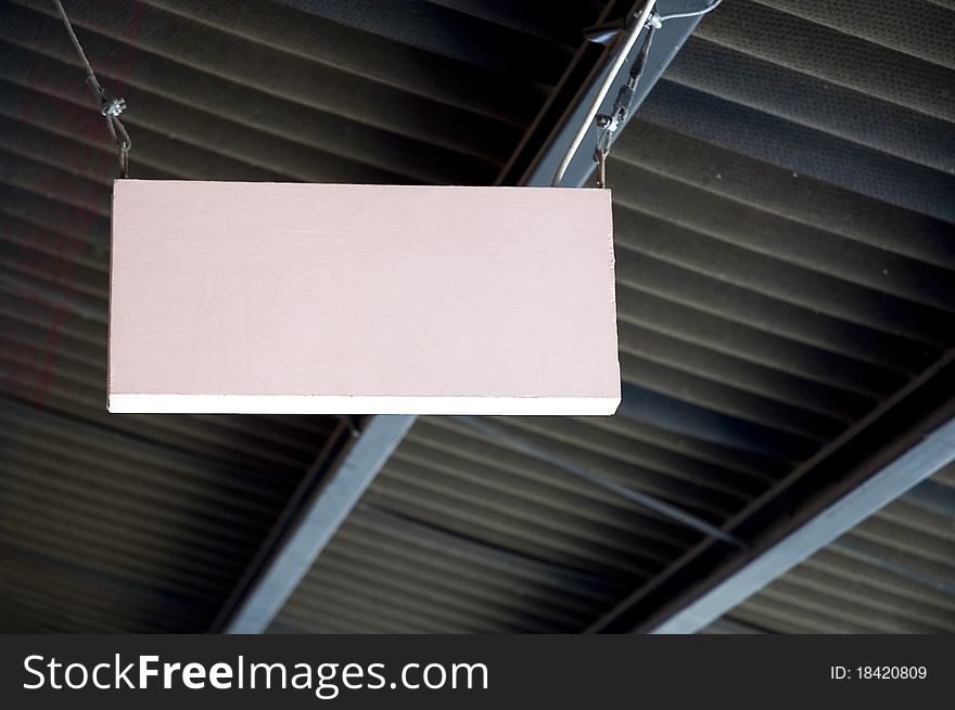 Pink wooden blank signage hanging on the ceiling. Pink wooden blank signage hanging on the ceiling.