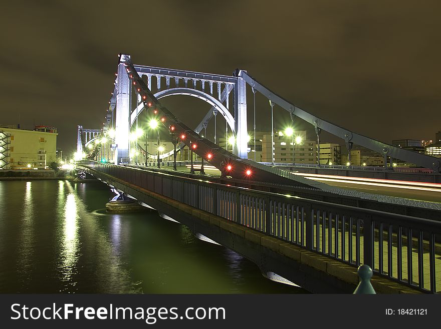 Night time colorful reflection of Kiyosu Bridge illumination in waters of SumidaÃ‚Â river of Tokyo , Japan