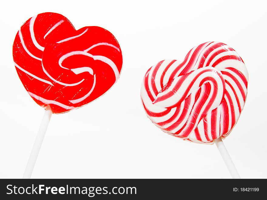 Retro style red , pink heart shape lollipop on white background