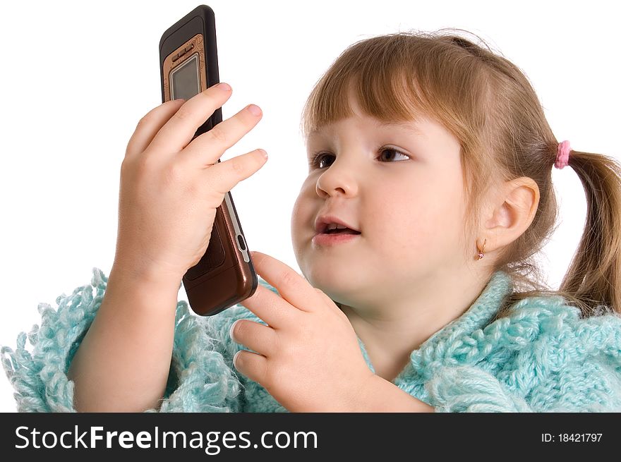 The little girl speaks by phone on white