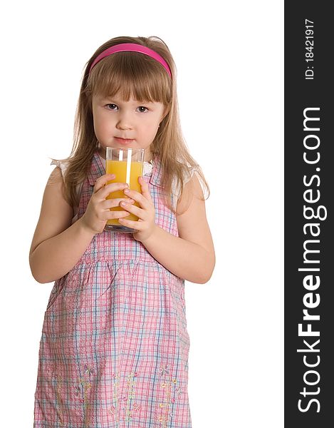 The little girl drinks orange juice on white