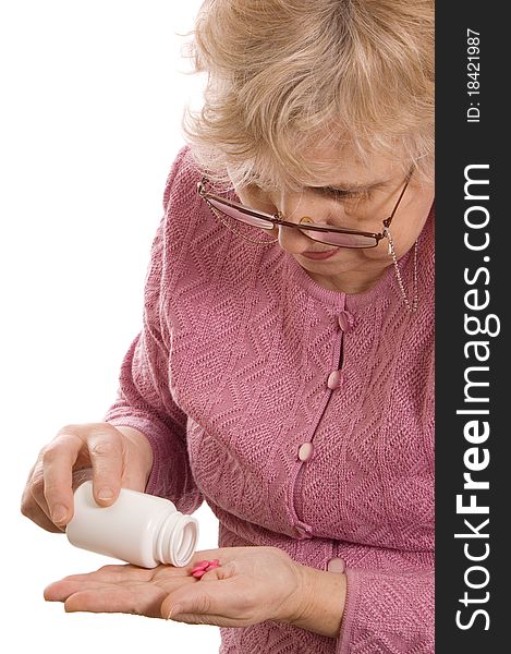 The elderly woman with tablets on white