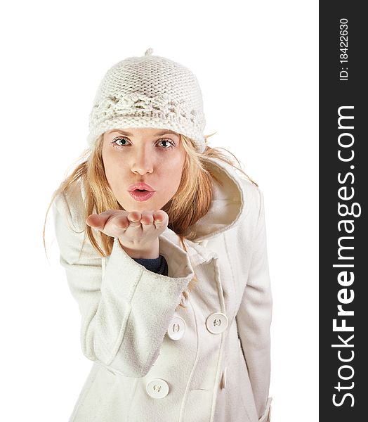 Blond girl with winter cap sends kiss. Blond girl with winter cap sends kiss