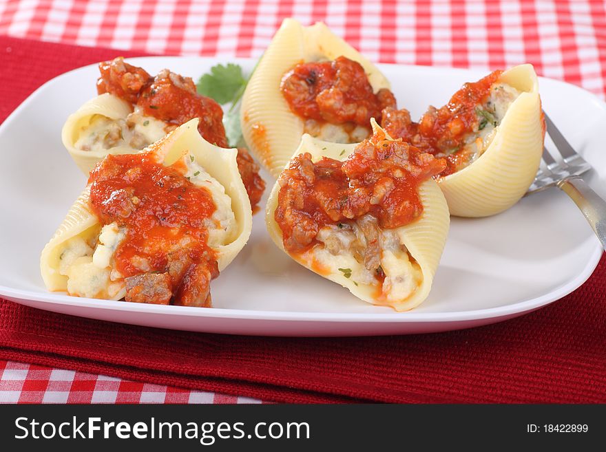 Stuffed pasta shells with tomato sauce on a plate