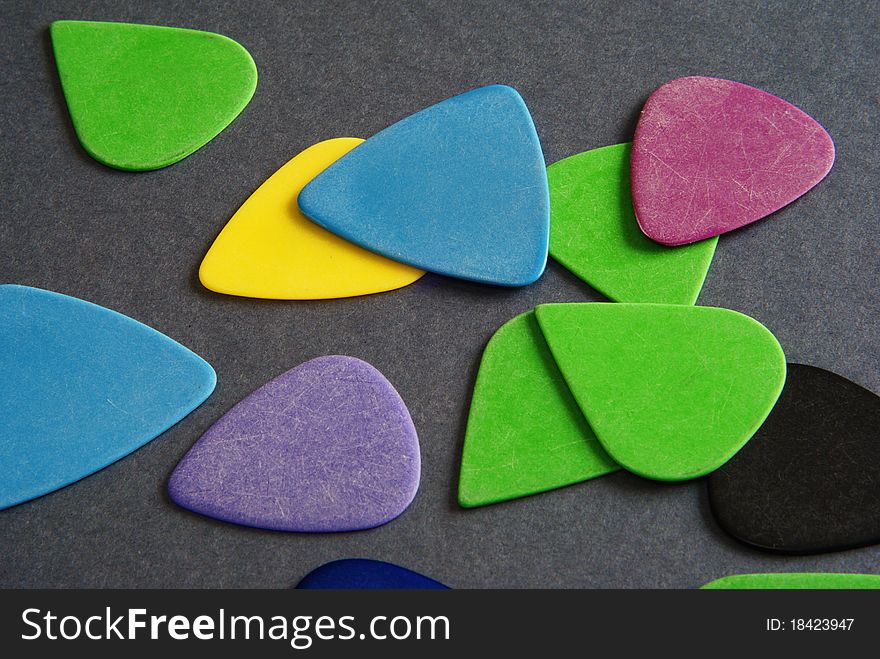 Guitar picks of different colors and shapes.