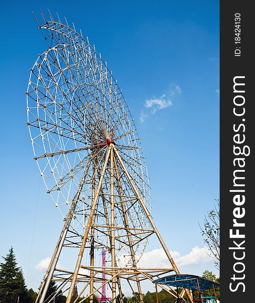 A Ferris wheel is repired in a park