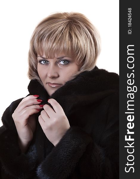 Adult blonde in a mink coat on a white background