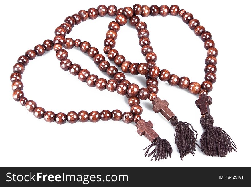 Wooden rosary isolated on white background close up