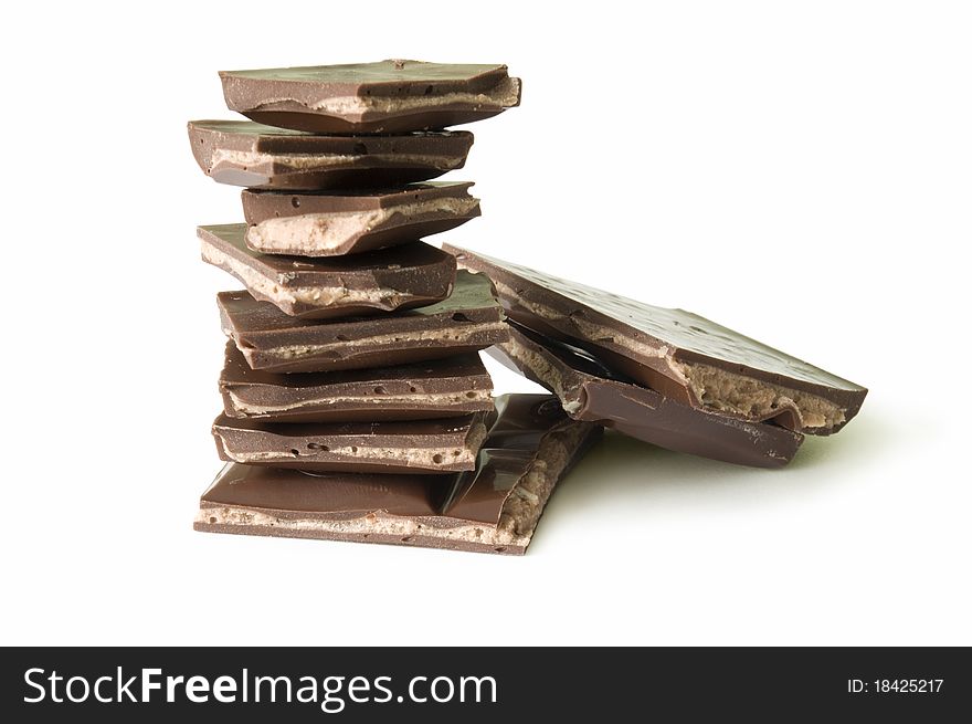 Stack Of Dark Chocolate Pieces, Isolated Over White