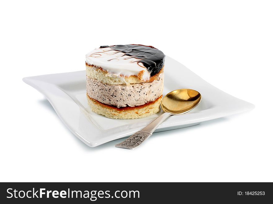 Dessert cake on a plate with a fork isolated on white background. Dessert cake on a plate with a fork isolated on white background