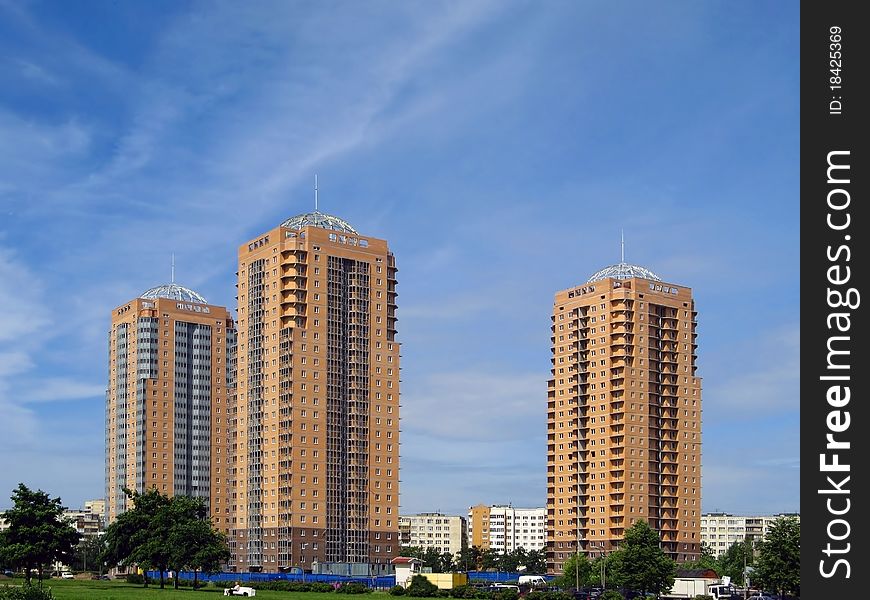 New towerlike buildings against a background of blue sky. New towerlike buildings against a background of blue sky