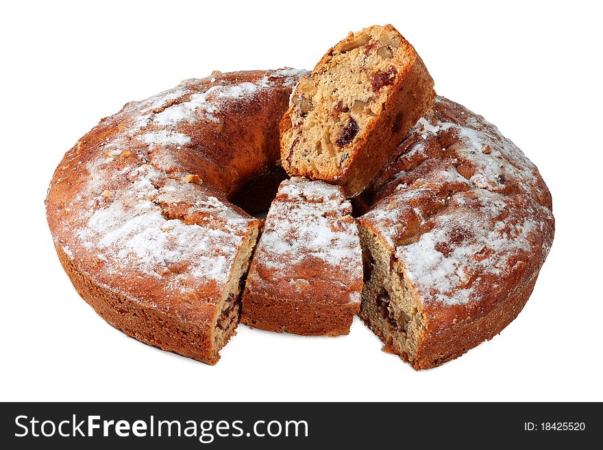 Cake with nuts, dusted with icing sugar isolated on a white background