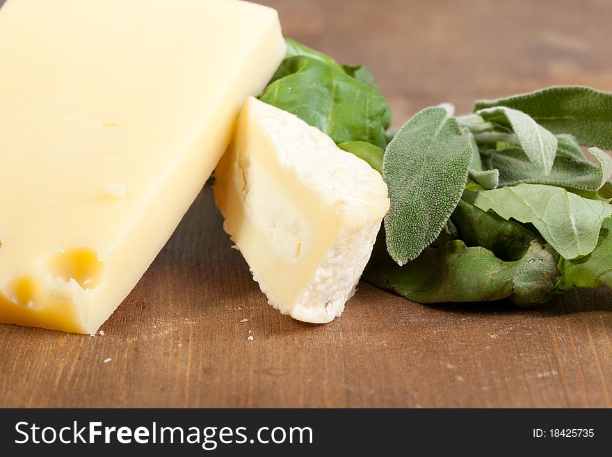 Tow kind of Cheese and fresh herbs on the wooden desk. Tow kind of Cheese and fresh herbs on the wooden desk