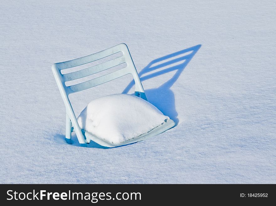 Chair covered in snow