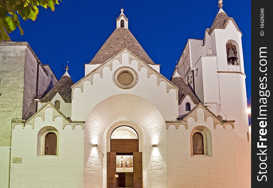 Illuminated church with special historical roof at night in south Italy