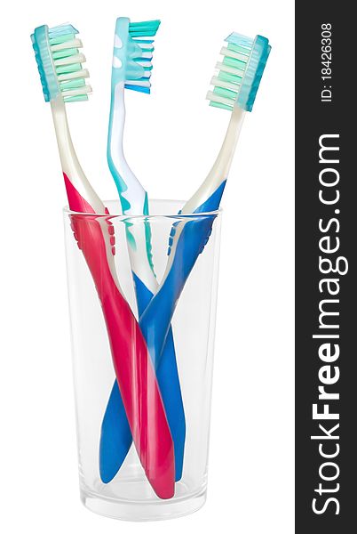 Three tooth brushes in glass. Isolated on white background. Clipping path. Three tooth brushes in glass. Isolated on white background. Clipping path.