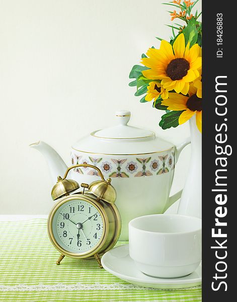 Alarm clock and cup for breakfast background