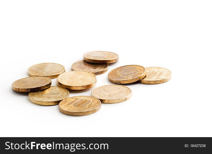 A lot of coins scattered on a white background. A lot of coins scattered on a white background