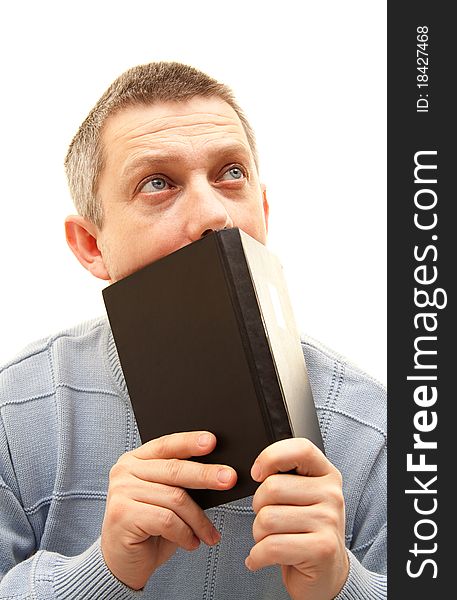 Young man with book looking up