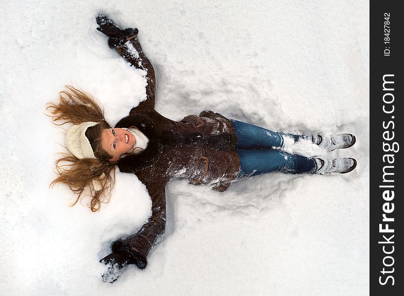 Young woman lying in the snow