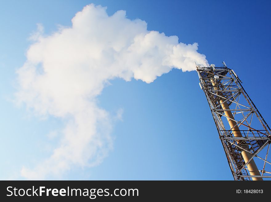 Gas. Smoke Leaving A Pipe. On Blue Sky