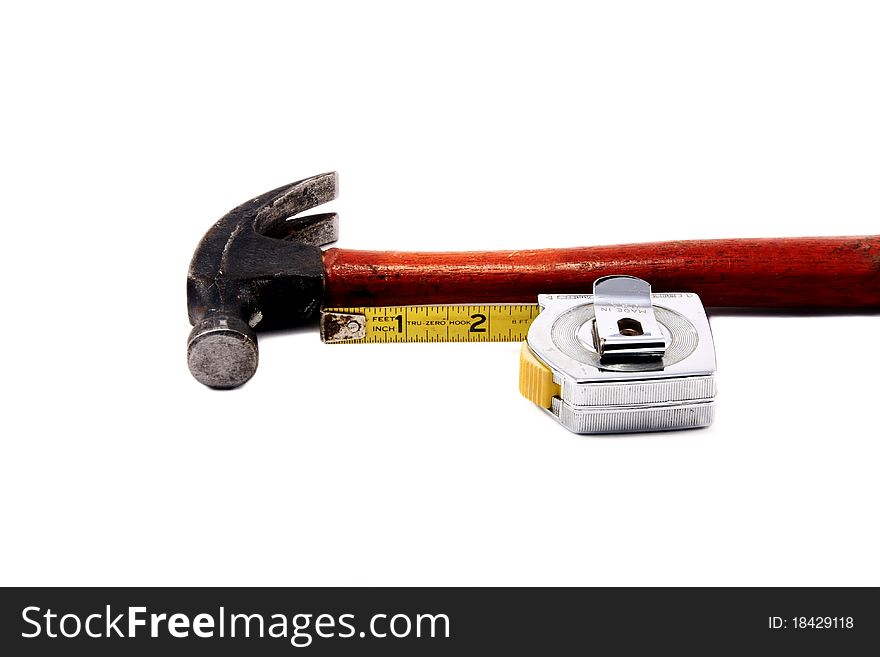 Well-used hammer and tape measurer; isolated on white background; one of series in portfolio