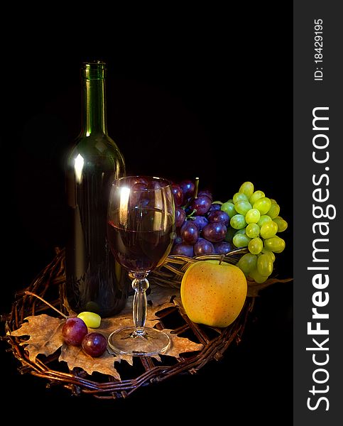 Wine and fruits on black background