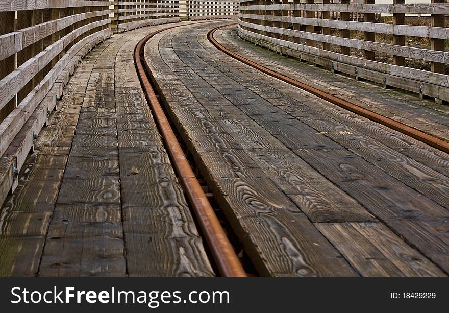 Railroad tracks on a bridge making a curve into the distance; one of a series of railroad images in portfolio. Railroad tracks on a bridge making a curve into the distance; one of a series of railroad images in portfolio