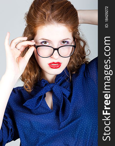 Portrait of beauty young woman with red hairs, in fashion eyeglasses