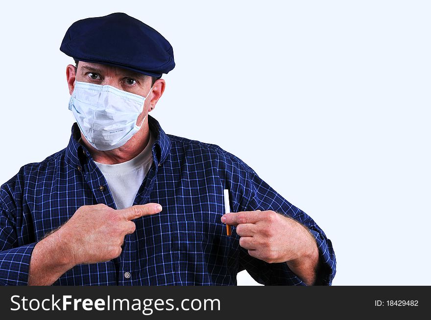 Man wearing a dust mask pointing at cigarette, alluding to how dangerous smoking can be to your health. Man wearing a dust mask pointing at cigarette, alluding to how dangerous smoking can be to your health.