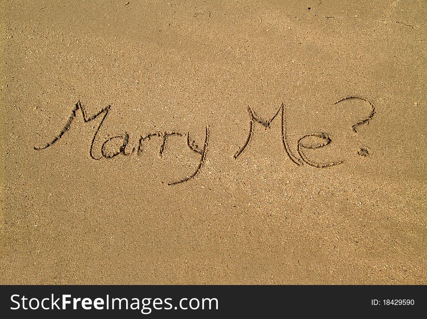 Marry me proposal written in the sand. Marry me proposal written in the sand