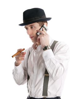 Young Man Talks By A Mobile Phone And Holds Cigar. Stock Photography Young Man Talks By A Mobile Phone And Holds Cigar. Stock Photography