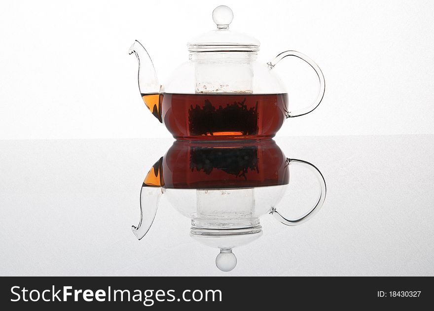 Glass transparent teapot on a white background. Glass transparent teapot on a white background