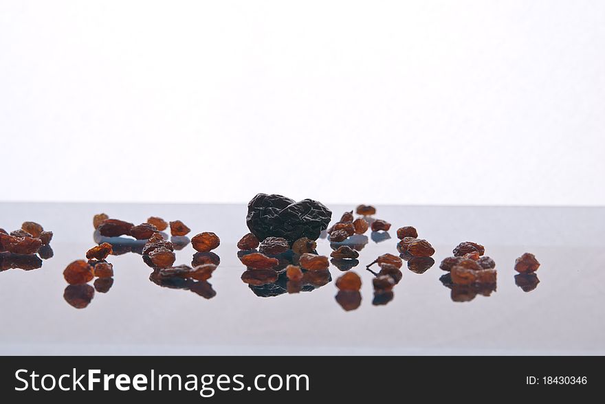 The dried fruit with reflection on a white background