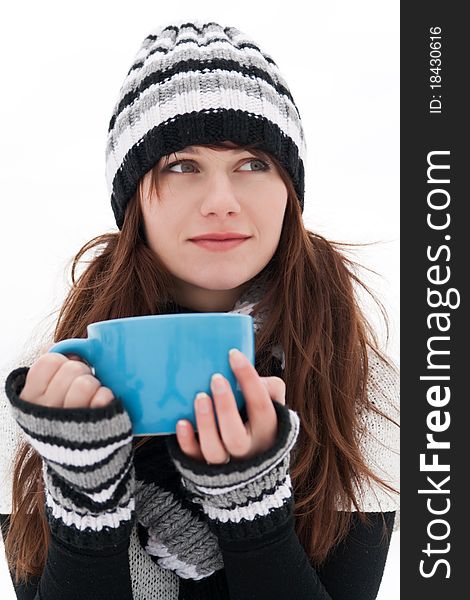 Young girl smiles, dreams, and holding a big blue cup. Young girl smiles, dreams, and holding a big blue cup