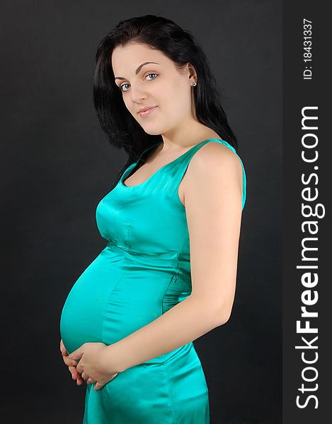 Profile portrait of the beautiful pregnant woman