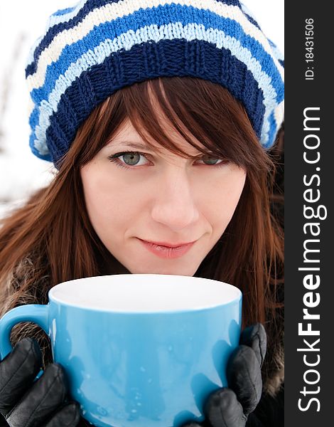 Young girl holding a big blue cup. Young girl holding a big blue cup