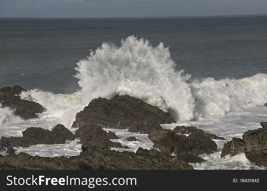 Crashing wave on rocks.