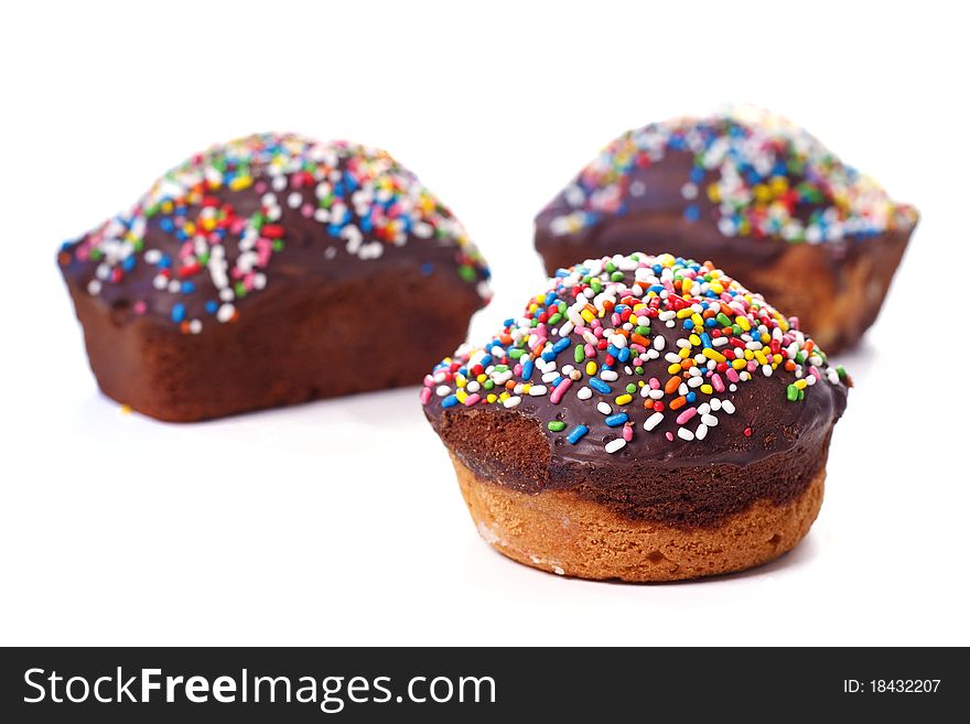 Three chocolate cakes with multicoloured truffle, for party, isolated on white background. Three chocolate cakes with multicoloured truffle, for party, isolated on white background